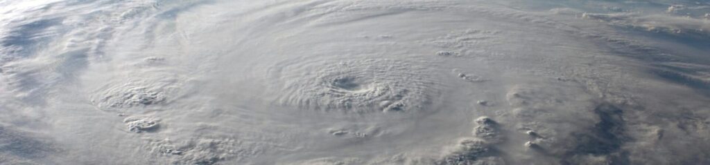 A stunning aerial view of Earth with a massive swirling hurricane, highlighting meteorological beauty.